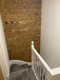A well-maintained staircase featuring charming ...