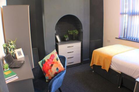 This inviting double bedroom features a cozy la...