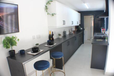 This stylish kitchen features a sleek design wi...