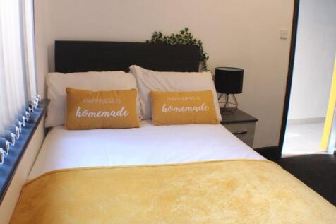 This charming double bedroom features a cozy at...