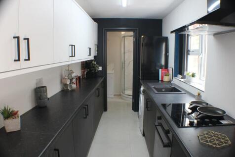 A modern kitchen featuring sleek black and whit...