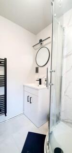 A modern bathroom featuring a sleek design with...