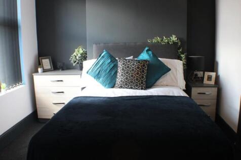 This inviting double bedroom features a comfort...