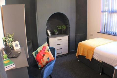 This inviting double bedroom features a cozy be...