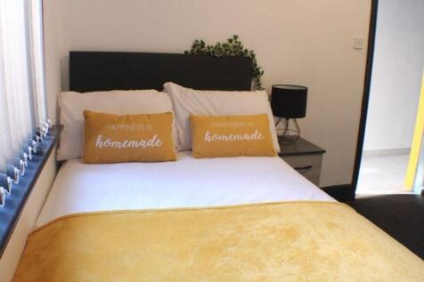This cozy double bedroom features a comfortable...