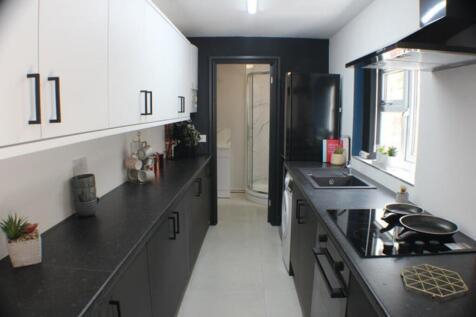 A modern kitchen featuring sleek black and whit...
