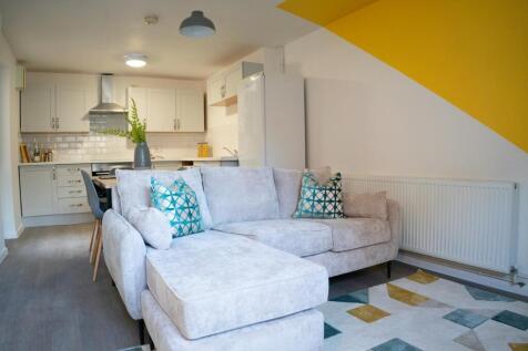 A spacious and inviting modern living room with...