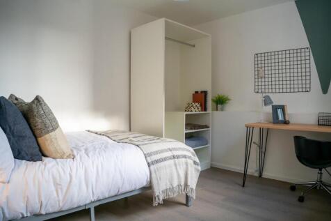 A bright and tidy double bedroom featuring a co...