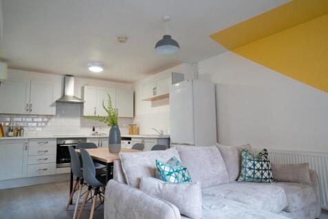 A modern and inviting kitchenette with ample sp...