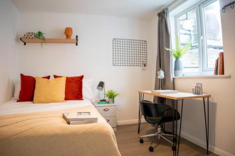 A bright and inviting double bedroom featuring ...