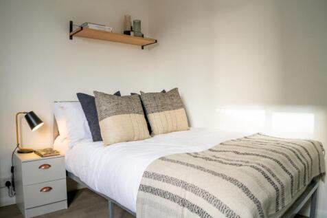 A bright and inviting double bedroom featuring ...