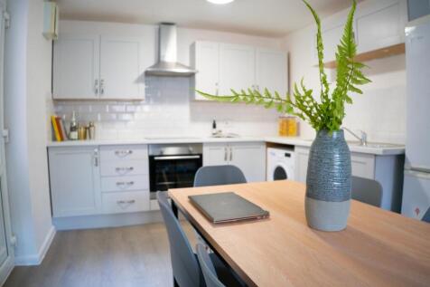 A modern and well-lit kitchenette with a stylis...