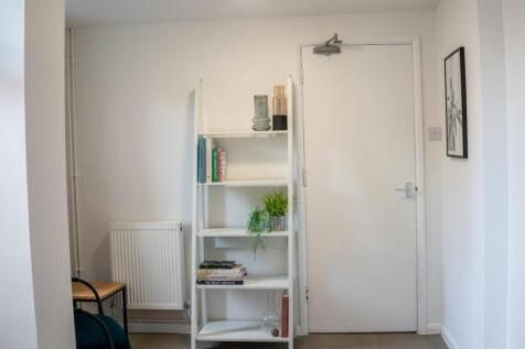 A bright and tidy hallway with modern decor and...
