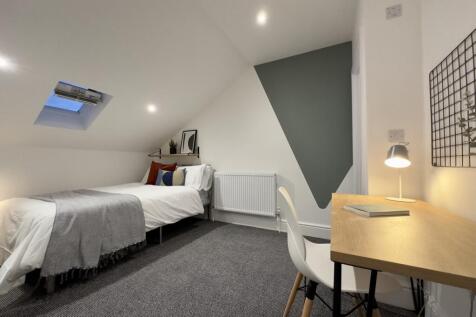 A bright and inviting double bedroom featuring ...