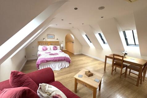 A bright and spacious double bedroom featuring ...