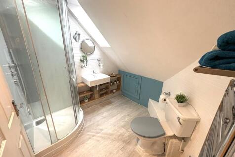 A stylish and modern bathroom featuring a spaci...