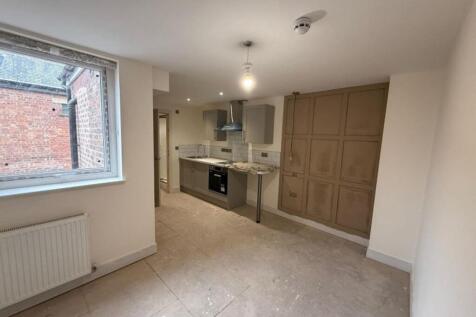 A bright and modern kitchen featuring sleek cab...