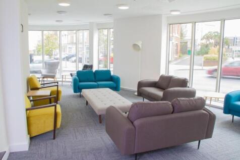 Spacious and well-lit communal lounge featuring...