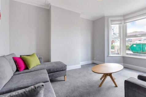 This stylish living room features a comfortable...