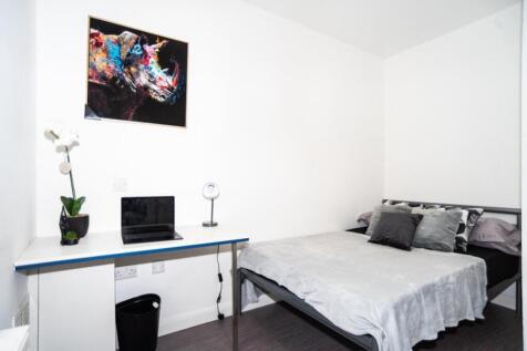 This inviting double bedroom features a comfort...