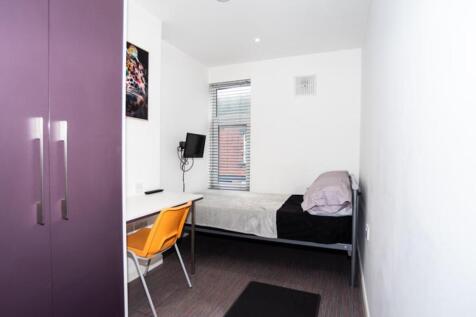 This inviting double bedroom features a comfort...