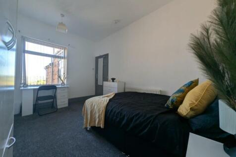 This spacious double bedroom features large win...