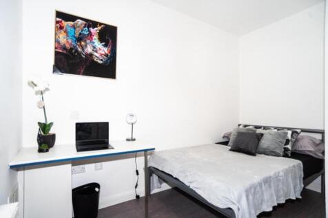 This inviting double bedroom features a comfort...