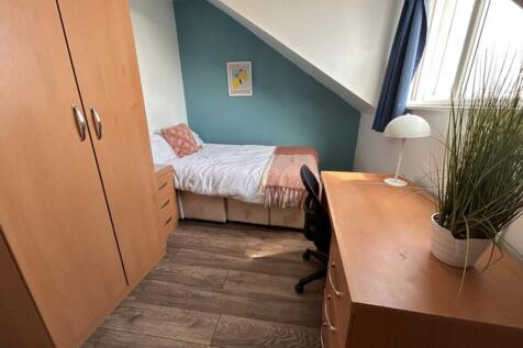 Cozy double bedroom featuring a comfortable bed...