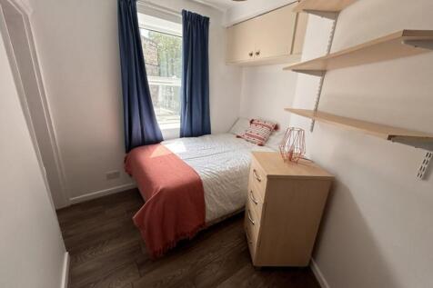 Cozy double bedroom featuring ample natural lig...