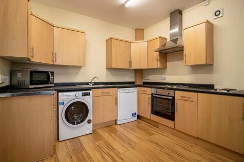 Modern kitchen featuring ample storage space, a...