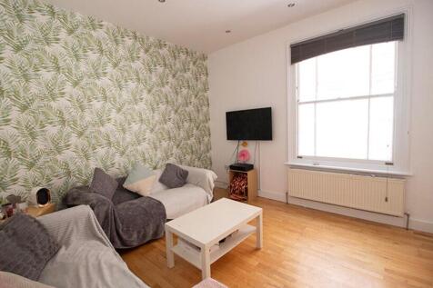 Bright and inviting living room featuring styli...