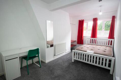 Spacious double bedroom featuring large windows...