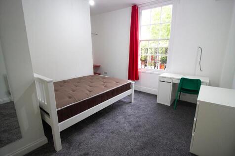 A bright and inviting double bedroom featuring ...