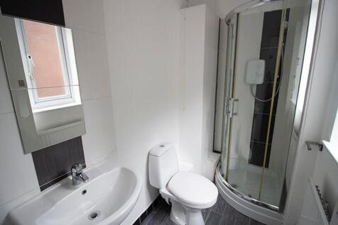 A modern bathroom featuring a sleek shower, sty...