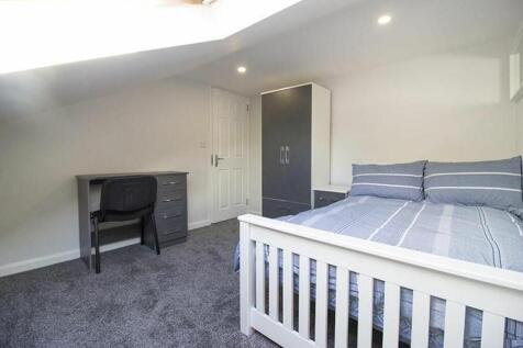 This inviting double bedroom features a comfort...