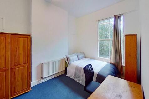 This inviting double bedroom features a comfort...