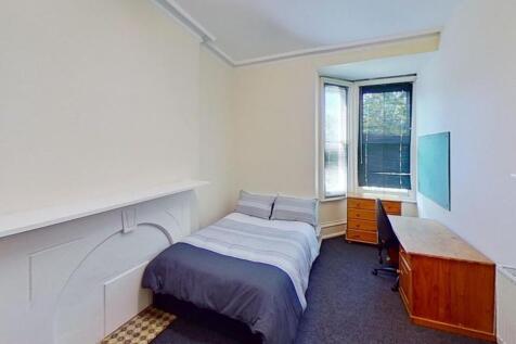 This inviting double bedroom features a cozy la...