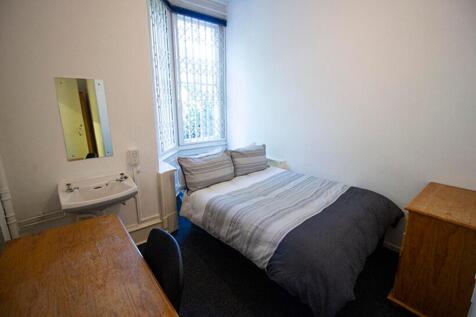 This inviting double bedroom features a cozy la...