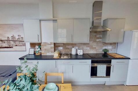 Modern kitchen with sleek cabinetry and stylish...