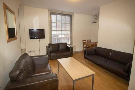 A spacious and inviting living room featuring m...