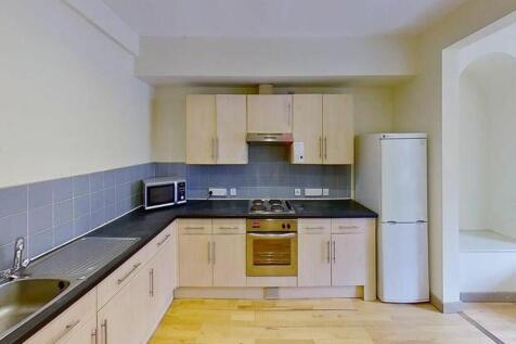 Modern kitchen featuring sleek cabinetry, ample...