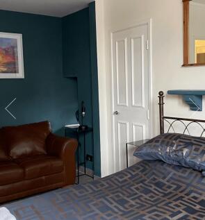 A cozy and inviting double bedroom featuring a ...