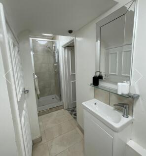 A modern and immaculate bathroom featuring a sp...