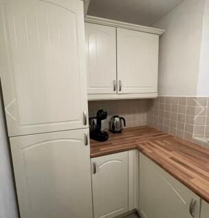 A tidy and functional kitchen with modern cabin...