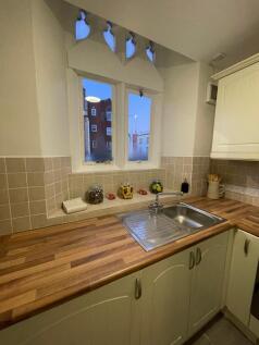 A charming kitchen featuring a well-maintained ...