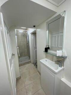 A modern bathroom featuring a sleek shower, sty...