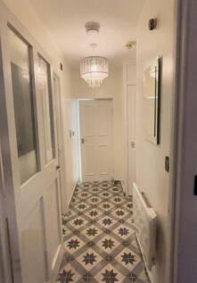 A stylish hallway featuring elegant lighting an...