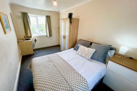This inviting double bedroom features a cozy la...
