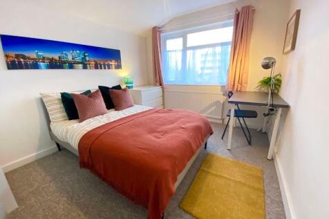 This inviting double bedroom features a cozy la...