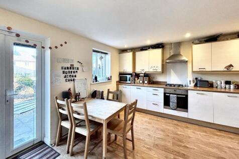 Spacious and modern kitchen featuring ample cou...